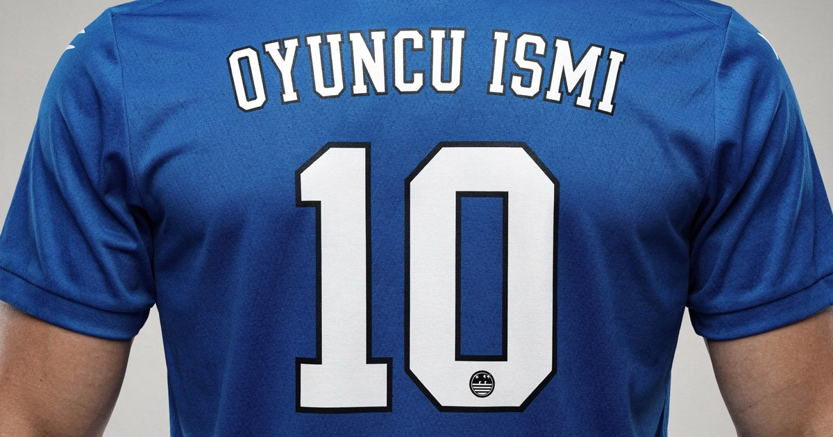 Forma yazı tipi örneği, mavi futbol forması sırtında Varsity blok font stiliyle basılmış OYUNCU ISMI yazısı ve 10 numarası. Siyah konturlu beyaz blok yazı tipi ile forma numara ve isim baskısı.